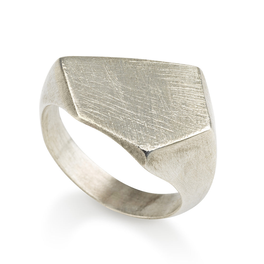 A silver ring with a geometric cutout design on the top part, with a matte finish.