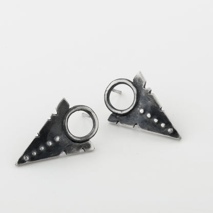 A pair of silver oxidized and brushed finish dotted path earrings on a white background