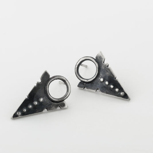 A pair of silver oxidized and brushed finish dotted path earrings on a white background