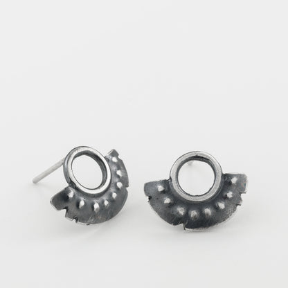 A pair of oxidized sterling silver dotted half moon earrings with a brushed finish, displayed against a white background.