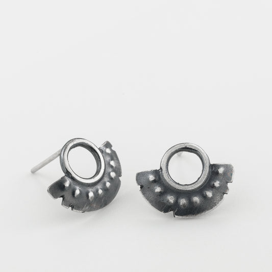 A pair of oxidized sterling silver dotted half moon earrings with a brushed finish, displayed against a white background.